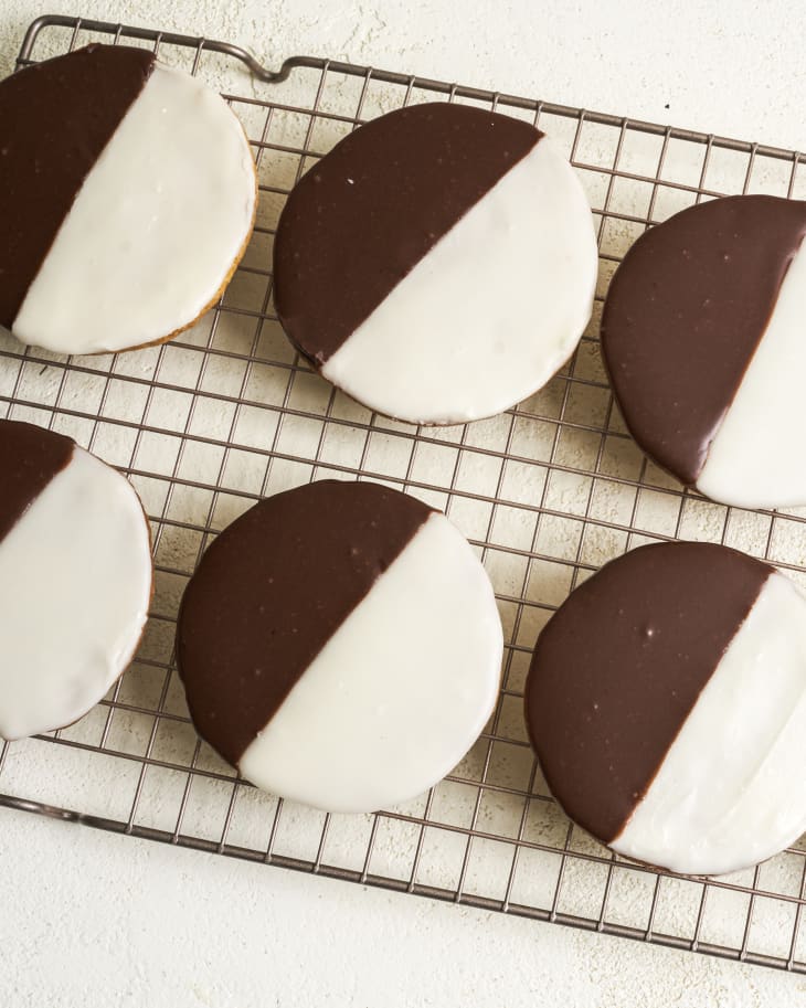 black and white cookies on a wire cooling rack
