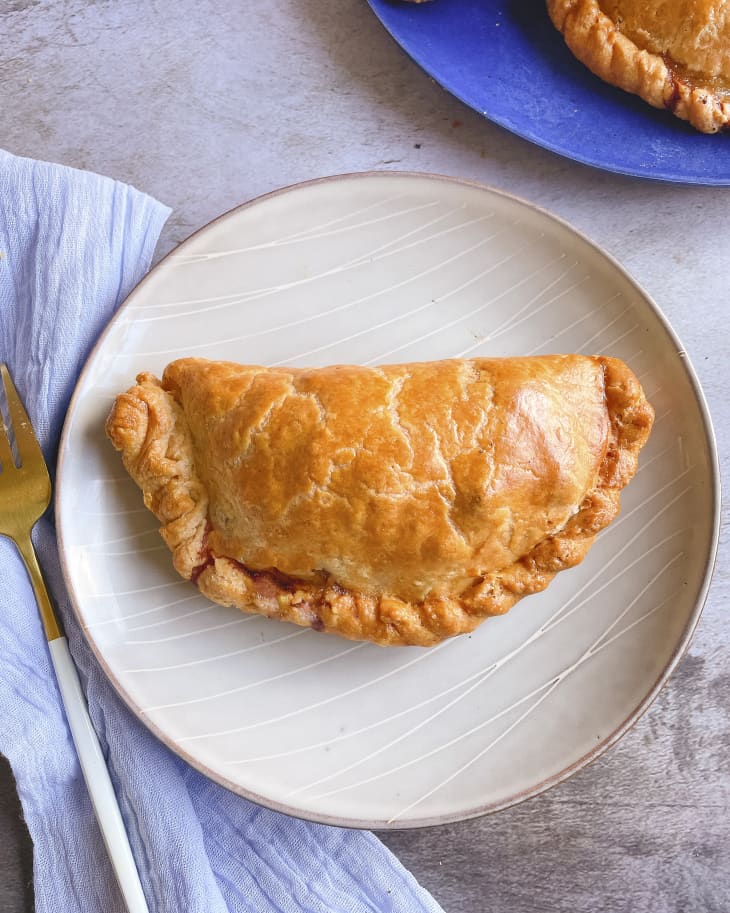 a pasty (A pastry case filled with beef, potato, and onion) on a plate