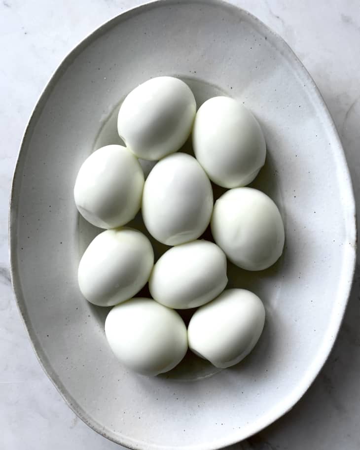 many hard boiled eggs on a gray plate