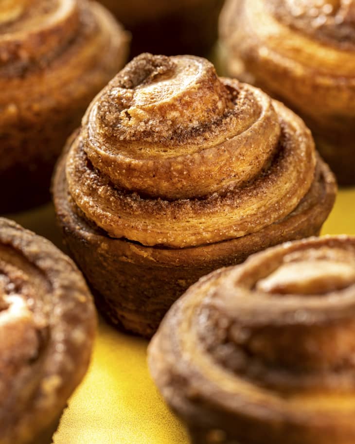 a browned, round, croissant in the shape of a muffin (known as a cruffin) as seen from side