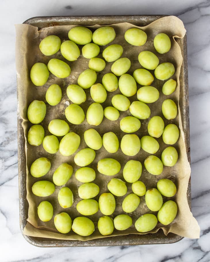 a tray of green frozen grapes.