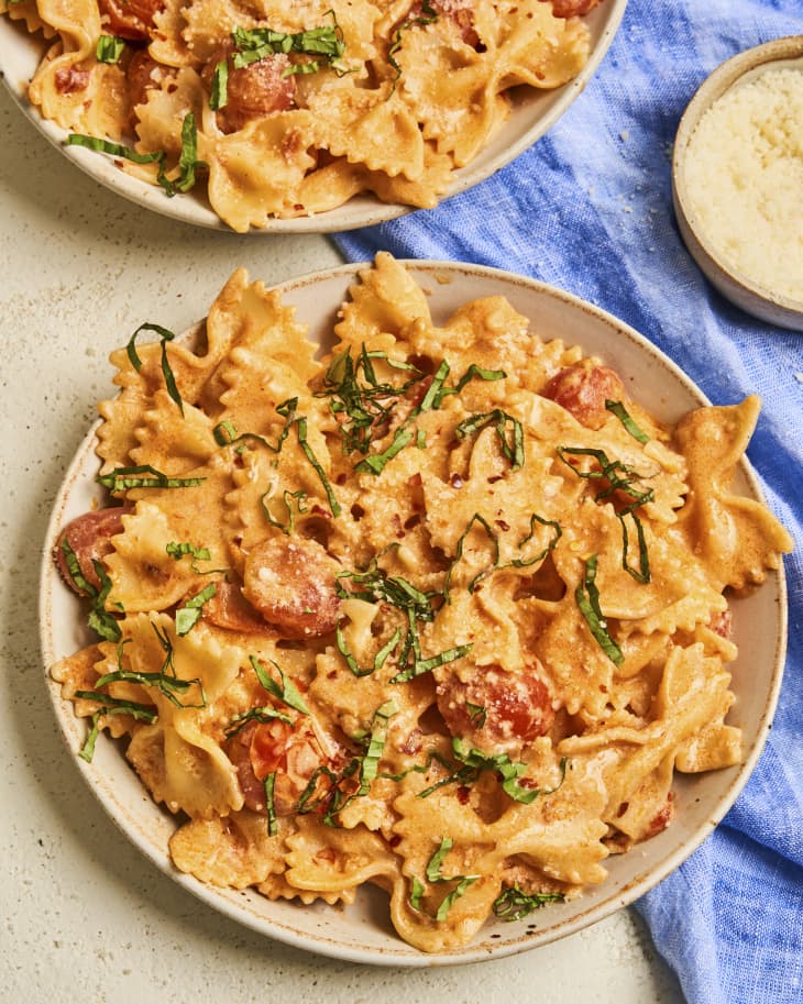 Bowtie pasta in a pink, creamy sauce, with shredded basil and tomatoes tossed it.