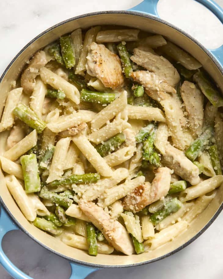 overhead  shot of lemon asparagus chicken pasta in a light blue pot, topped with cheese
