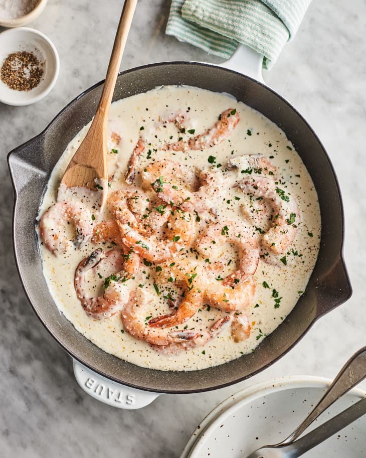 Skillet filled with a creamy sauce with garlic, parsley, and shrimp