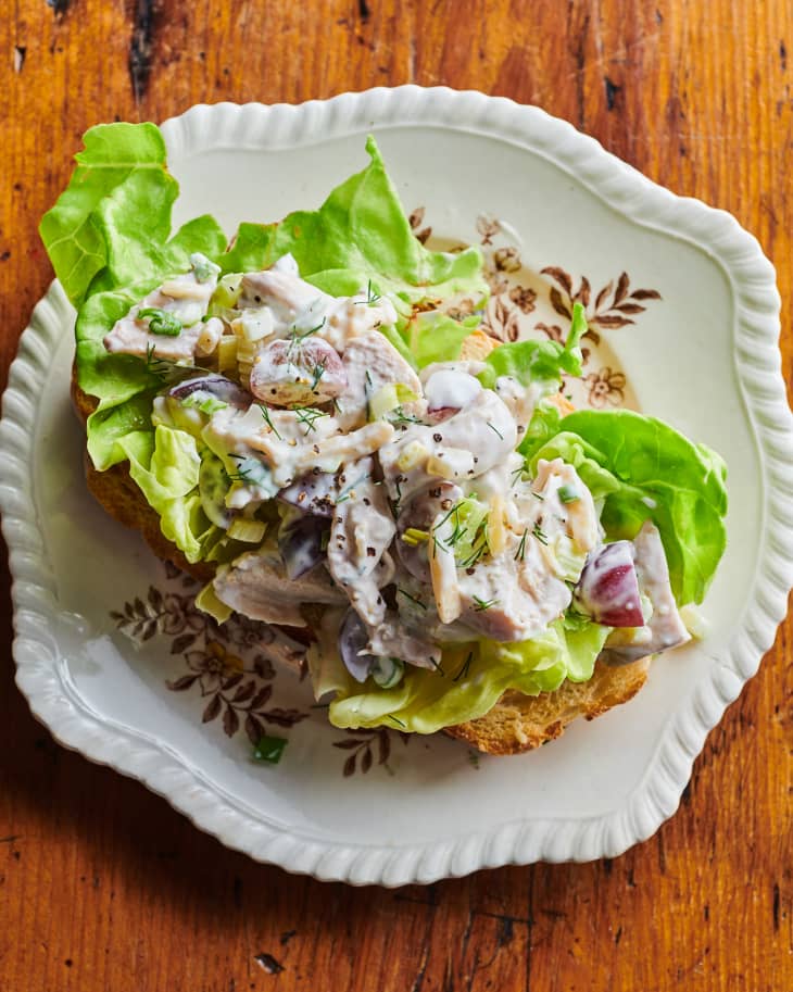 Chicken salad on lettuce on a piece of toast on a plate