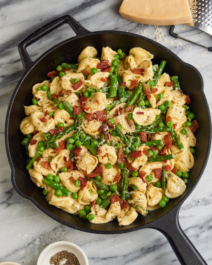 Creamy Tortellini with spring vegetables in cast iron skillet