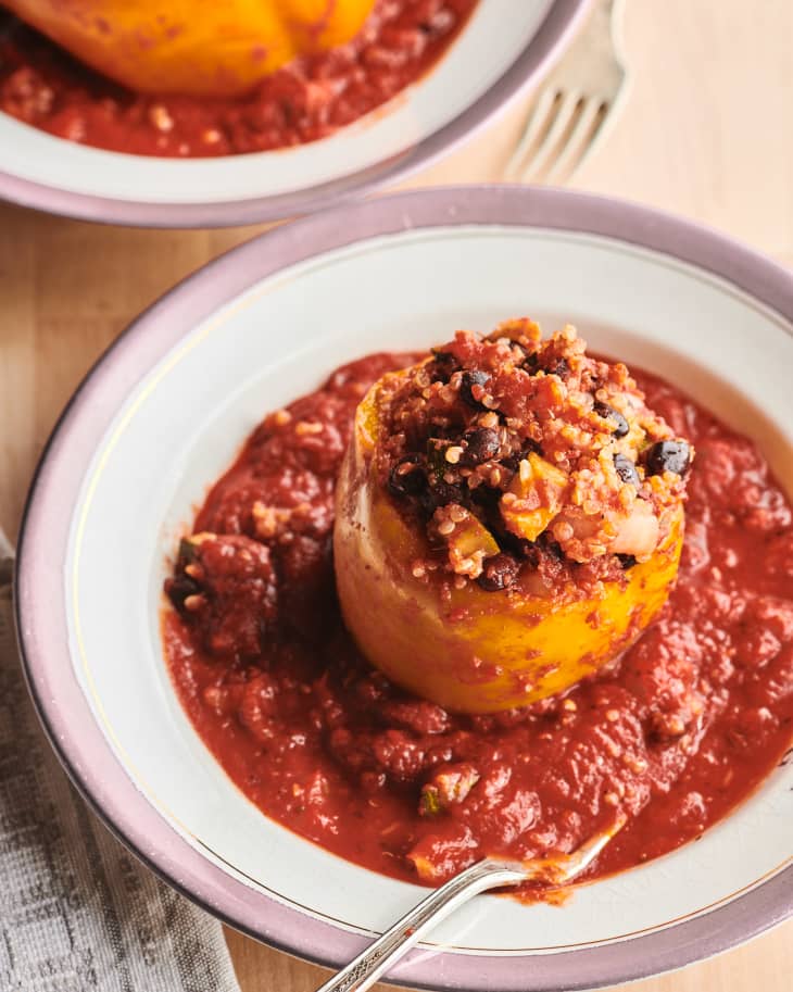 Vegetarian slow cooker stuffed bell peppers in bowl with fork on side.
