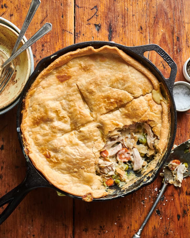 Turkey pot pie in skillet with portion sliced out.