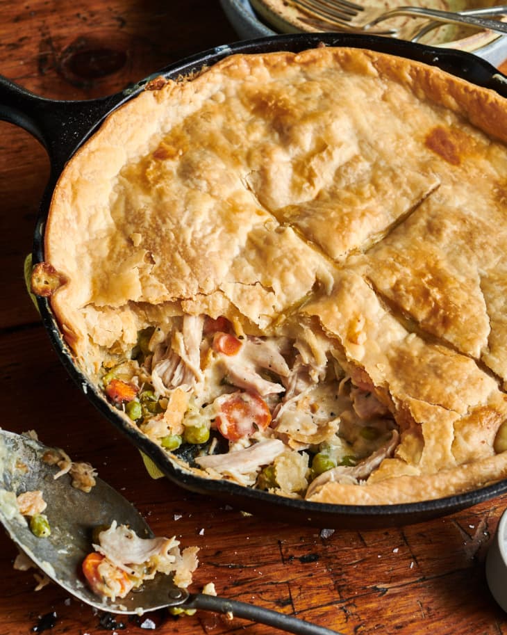 Turkey pot pie in skillet with portion sliced out.