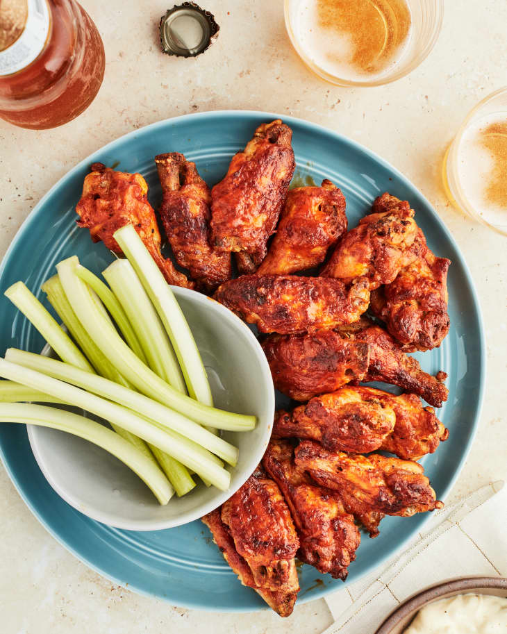 wings sit on a blue plate with celery