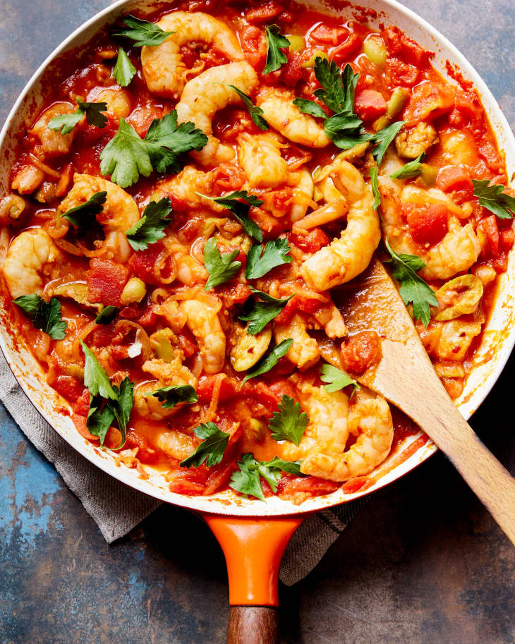 saffron shrimp with green olives in a pan