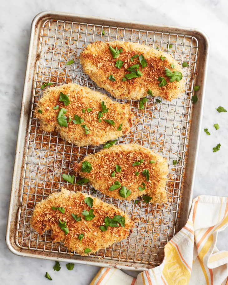 ranch chicken sits baked and garnished on a sheet pan