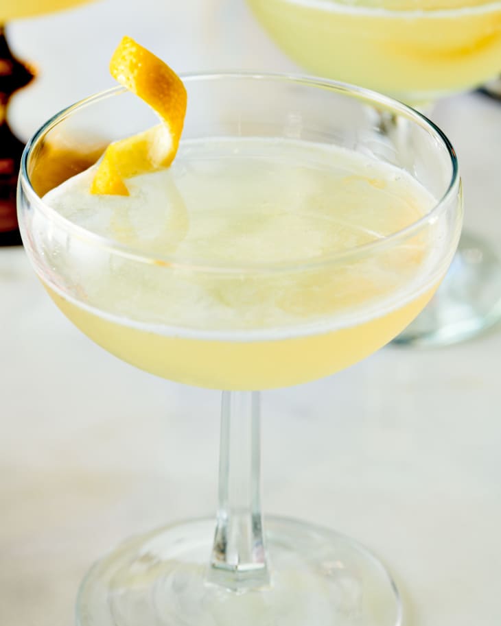 bees knees cocktail on a table with lemon garnish