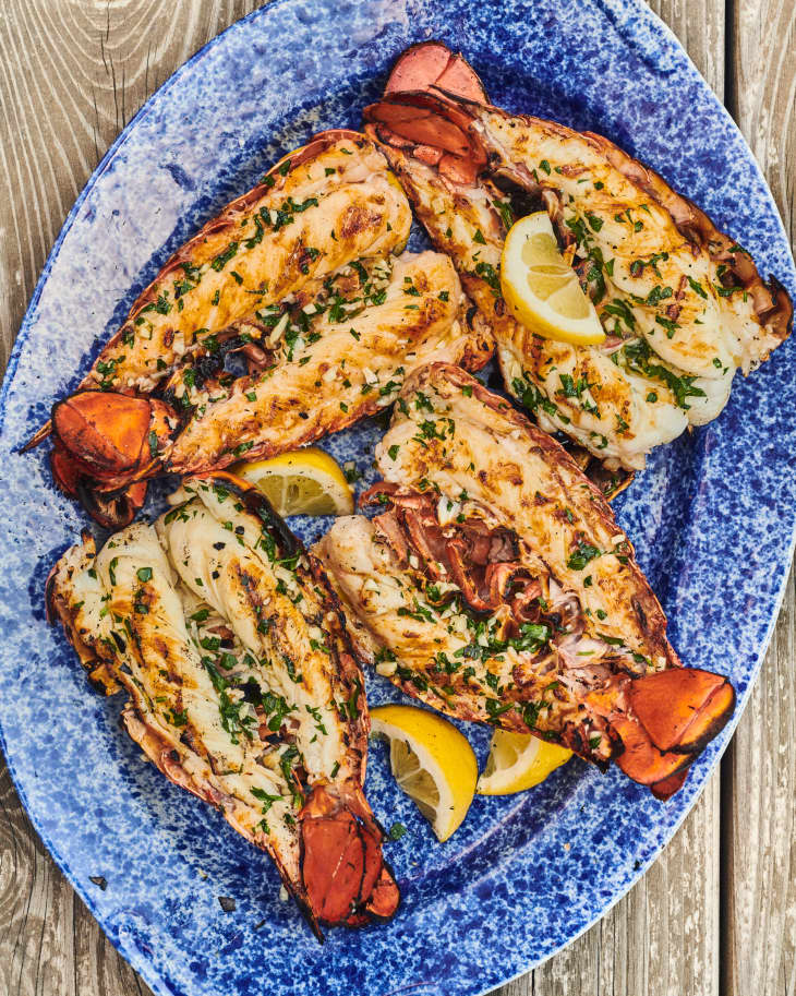 four grilled lobster tails on a plate
