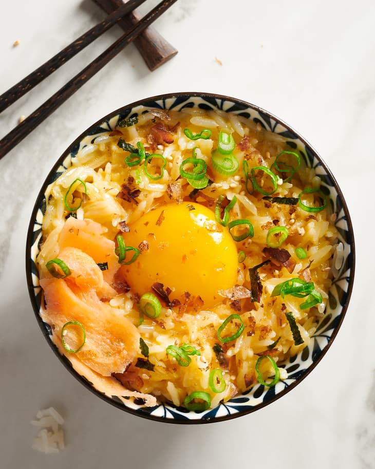 a fried egg sits on top of tomago kake gohan in a bowl