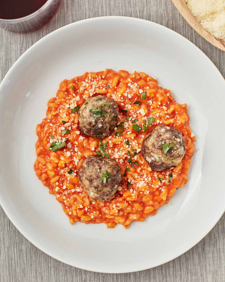 meatballs over tomato risotto in aw hite dish