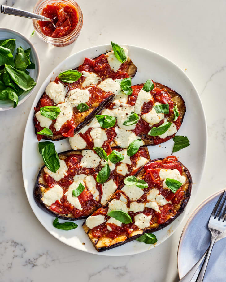 grilled eggplant parm with sauce being spooned on