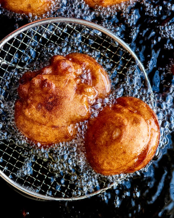 akara being pulled out of frying oil