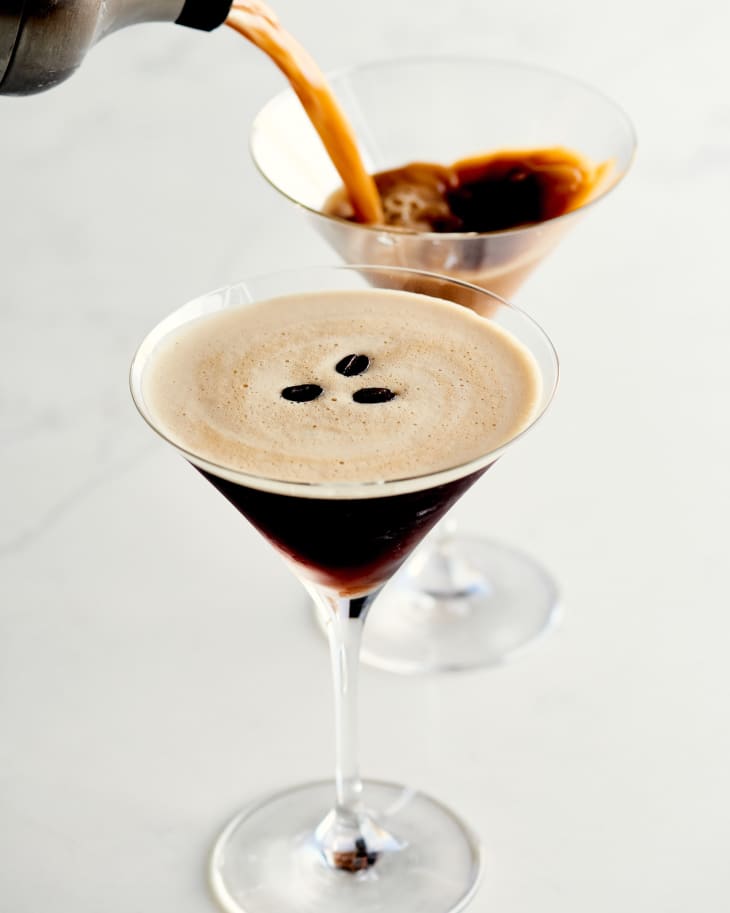 espresso martinis in glasses with one being poured