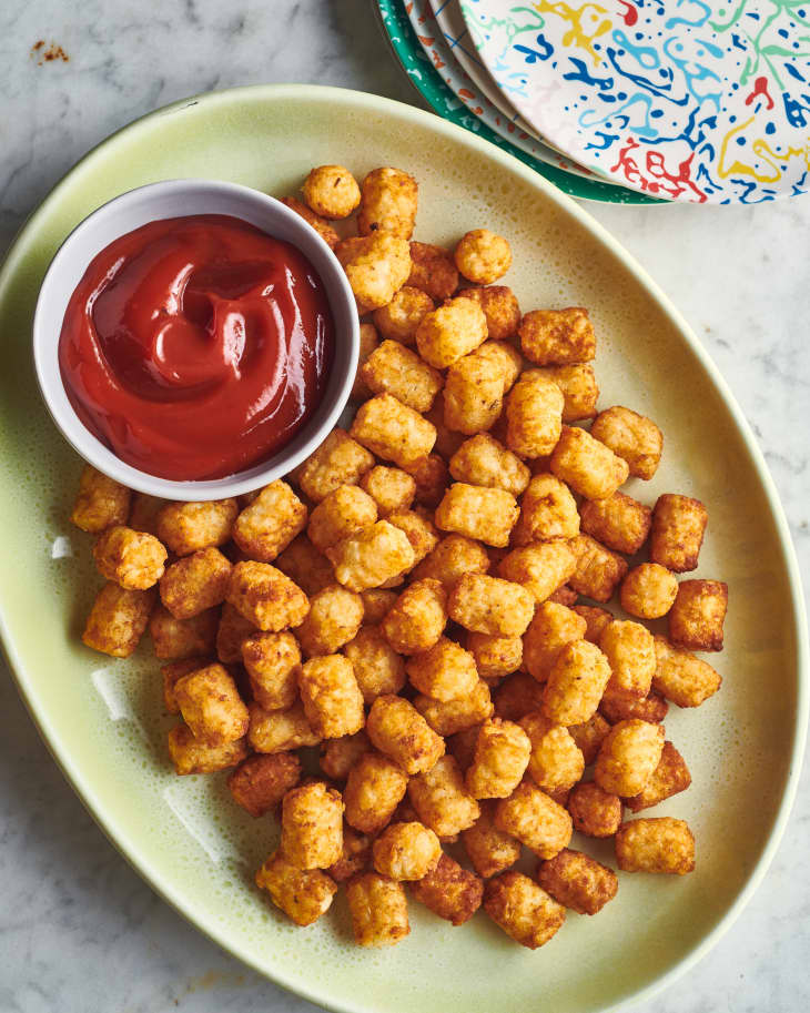 tater tots on a plate with ketchup
