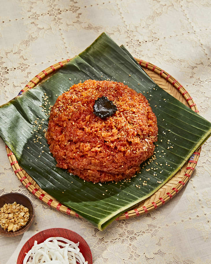 Red sticky rice on a banana-leaf-lined platter