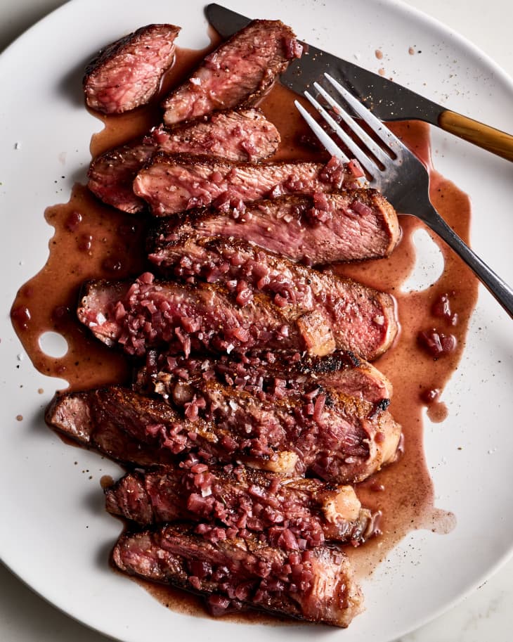 steak with red wine sauce, sliced on a platter