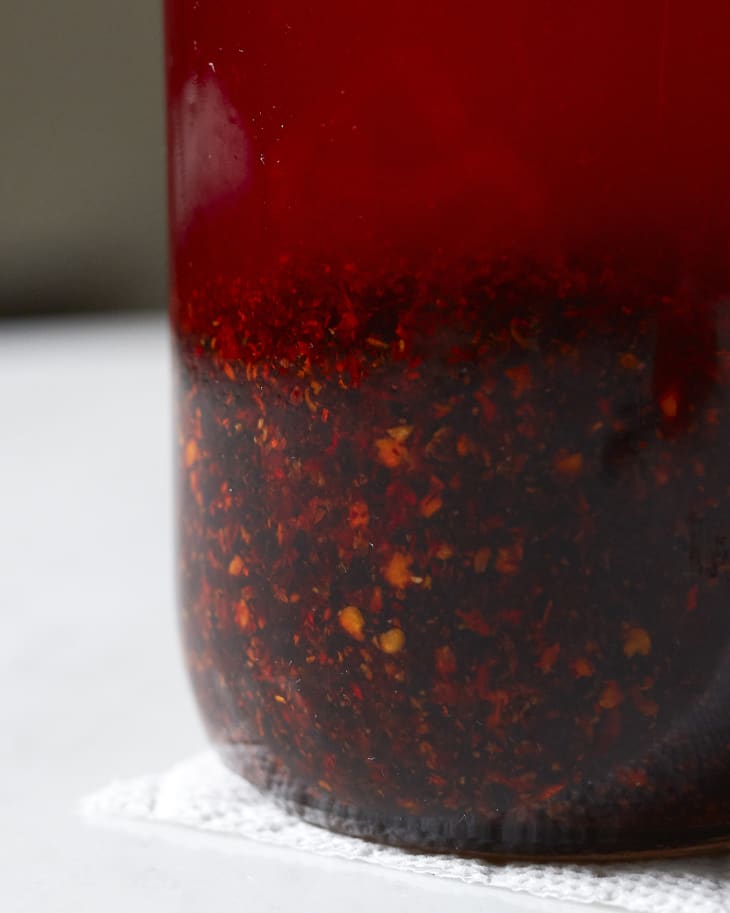 Chili oil in a glass jar.