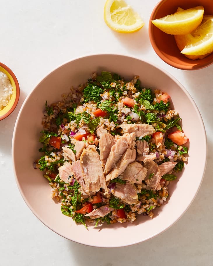tabbouleh in a bowl with drinks nearby