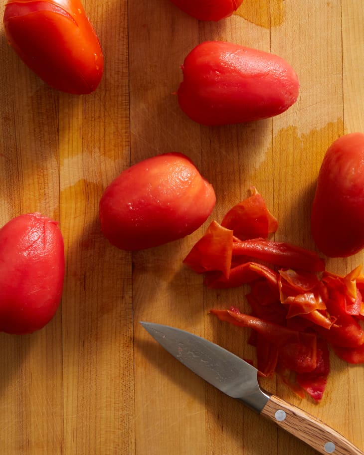 tomatos on the cutting board after being peeled