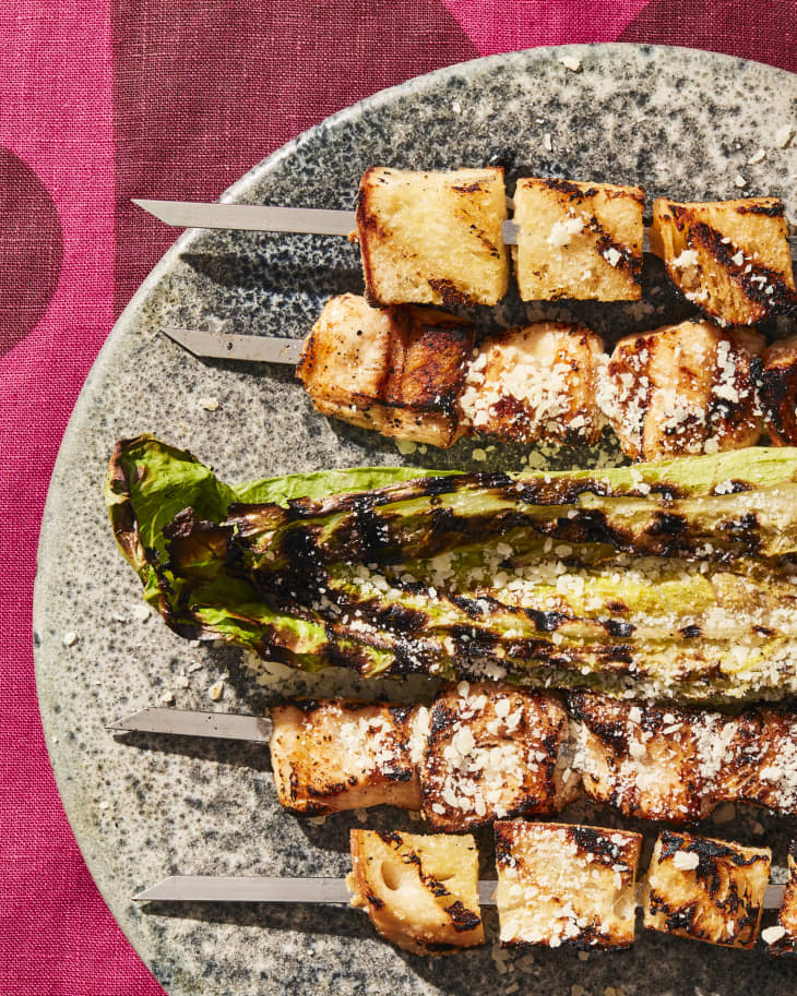 chicken caesar skewers a plate with a pink linen