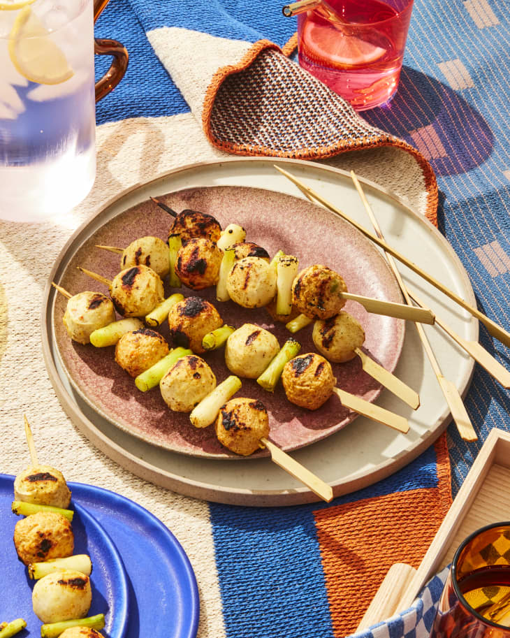fishball skewers on a plate with colorful napkins on background