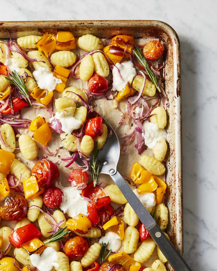 Sheet pan crispy gnocchi with roasted veggies topped with burrata.