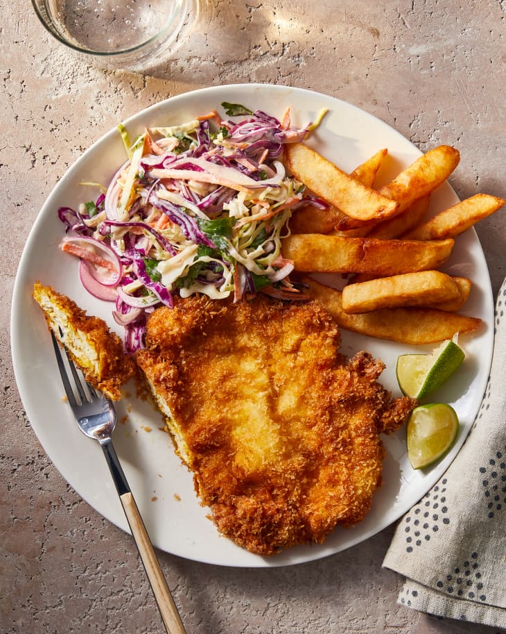 schnitzel on a plate with fries and Cole slaw