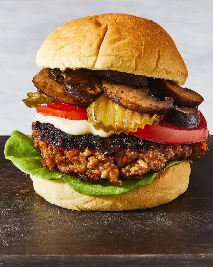 Photo of a meatloaf burger with meatloaf, potatoes, pickles, tomatoes, lettuce, mayo.