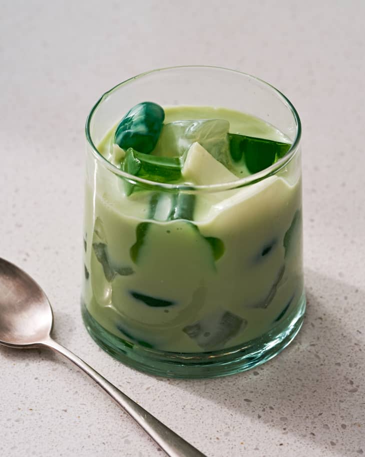 Photo of buko pandan in a glass, spoon sitting on the counter next to it