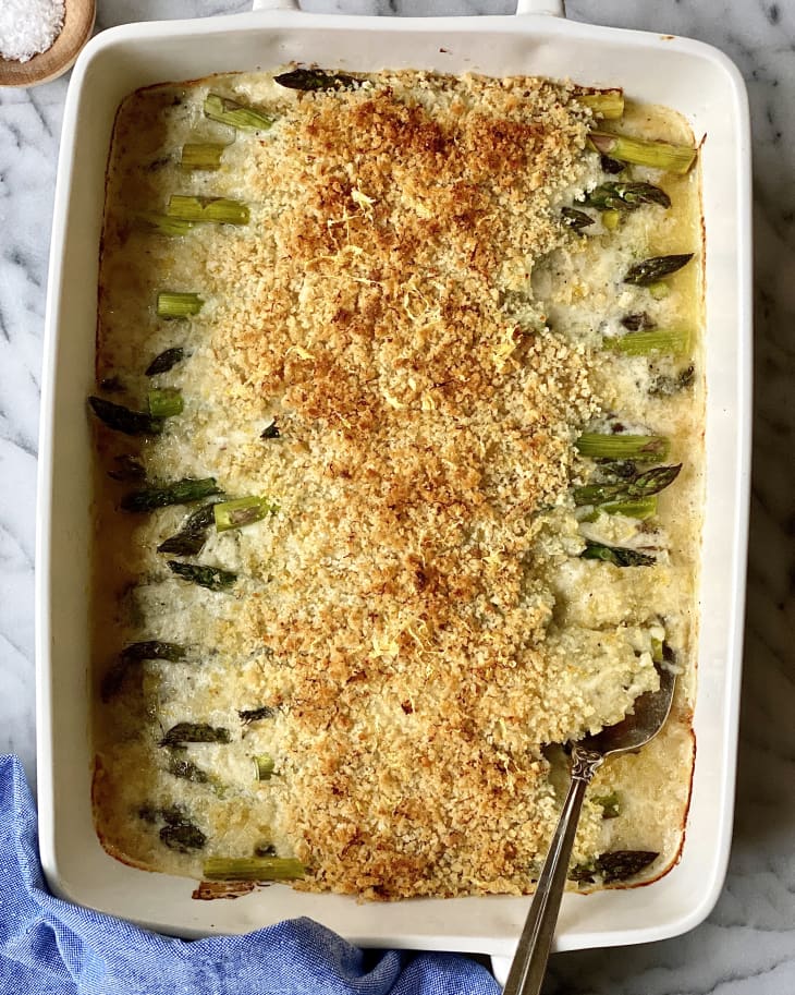 Asparagus casserole in a baking dish and serving spoon.