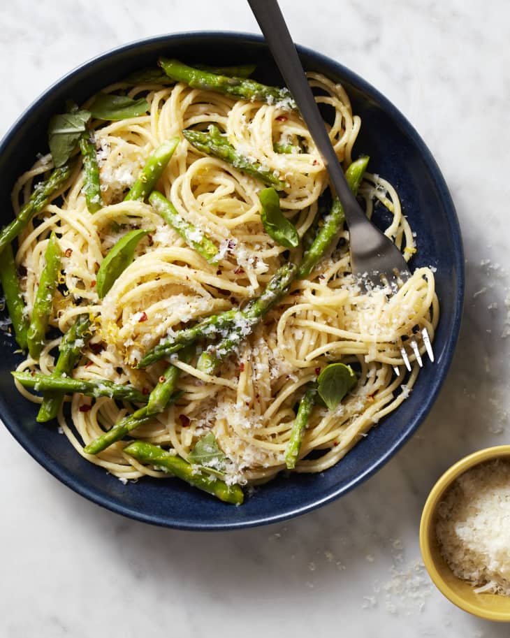 Asparagus pasta in serving bowl with fork.