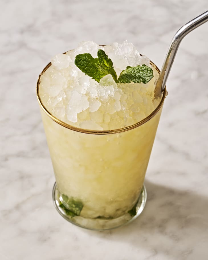 mint julep in a glass with mint on the bottom and top