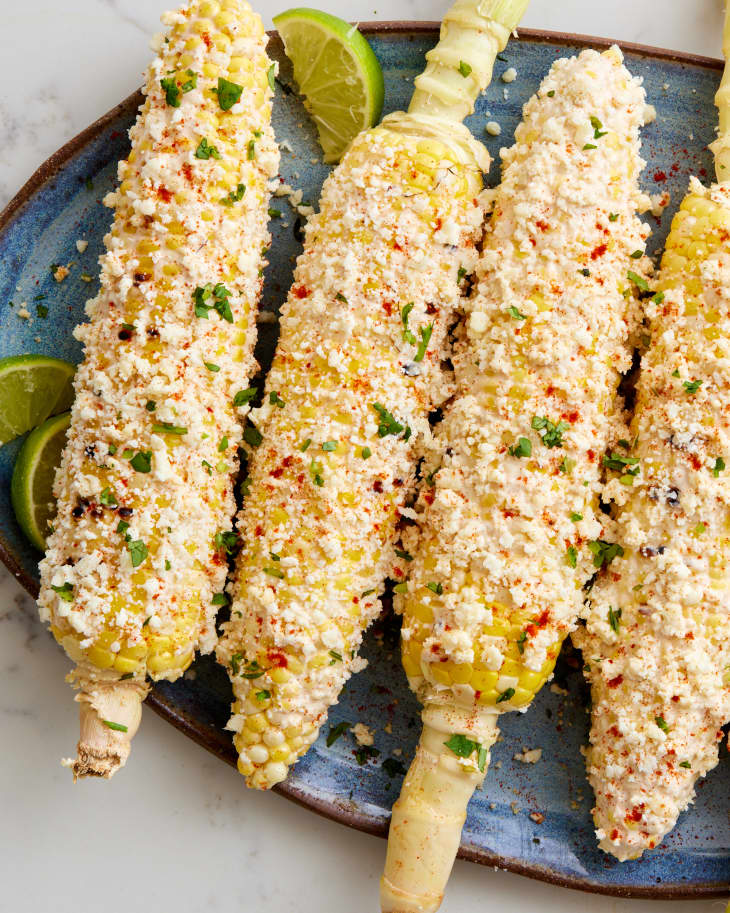 elote topped on a blue platter