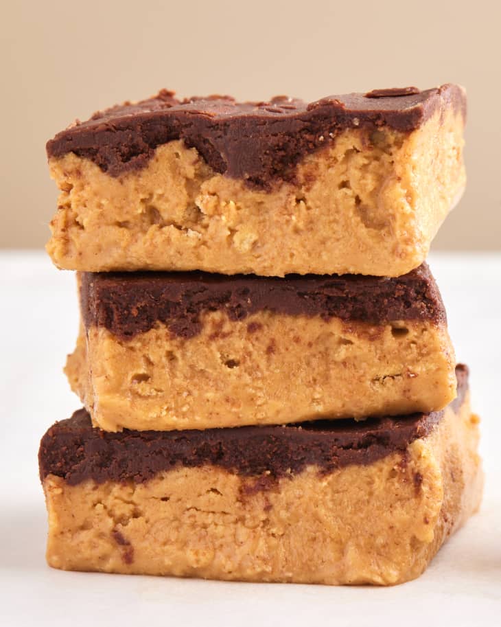 no bake peanut butter bars stacked on marble surface