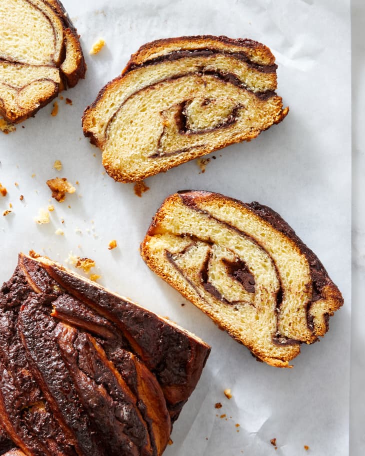 A sliced chocolate babka showing the texture and braided in chocolate.