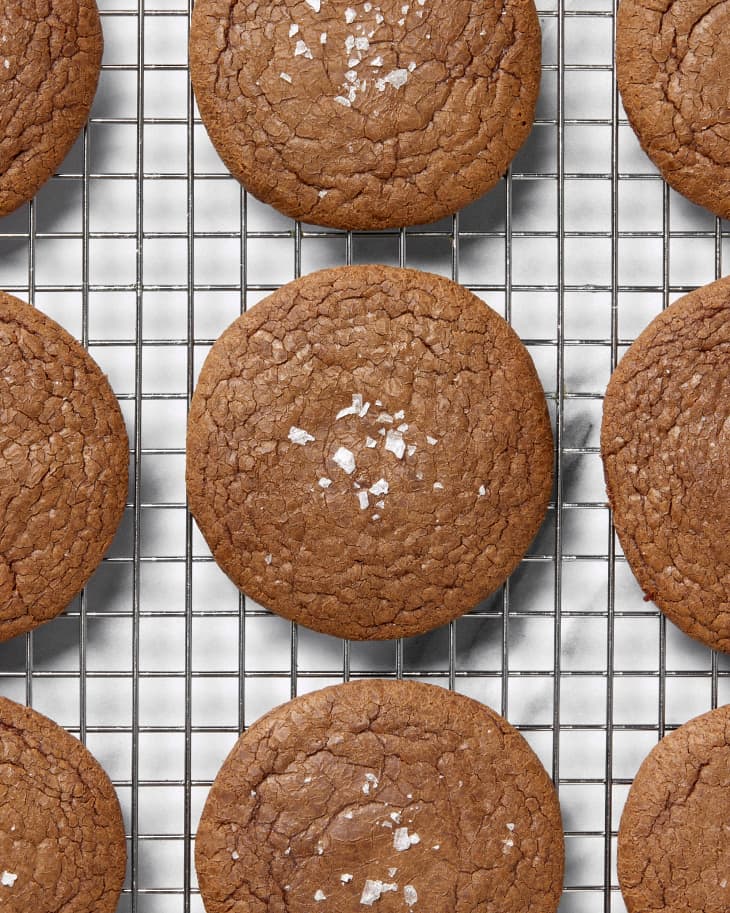 Overhead shot of nutella cookies on a baking sheet, all topped with flaky salt.