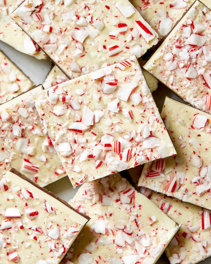 Overhead shot of pieces of peppermint bark, topped with crumbled candy cane.