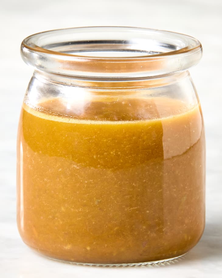 head on shot of the ginger dressing in a small jar.