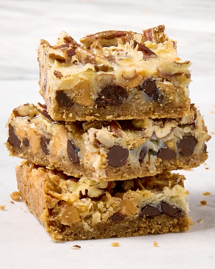 head on shot of three magic cookie bars stacked on each other, showing the chocolate chips inside.