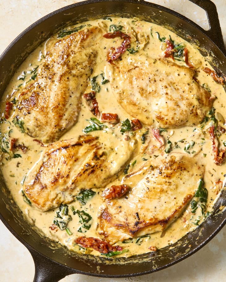 overhead shot of tuscan chicken in a cast iron skillet.
