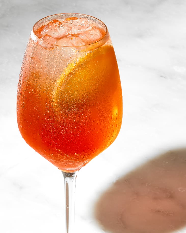 angled shot of a single aperol spritz, with condensation on the glass.