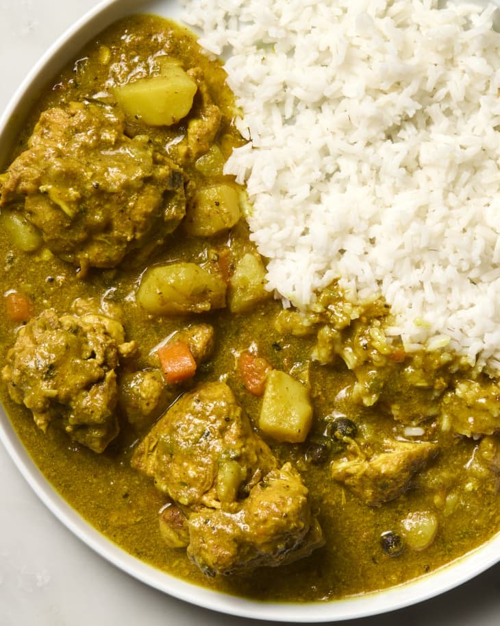 overhead shot of jamaican chicken curry on a plate, served with rice