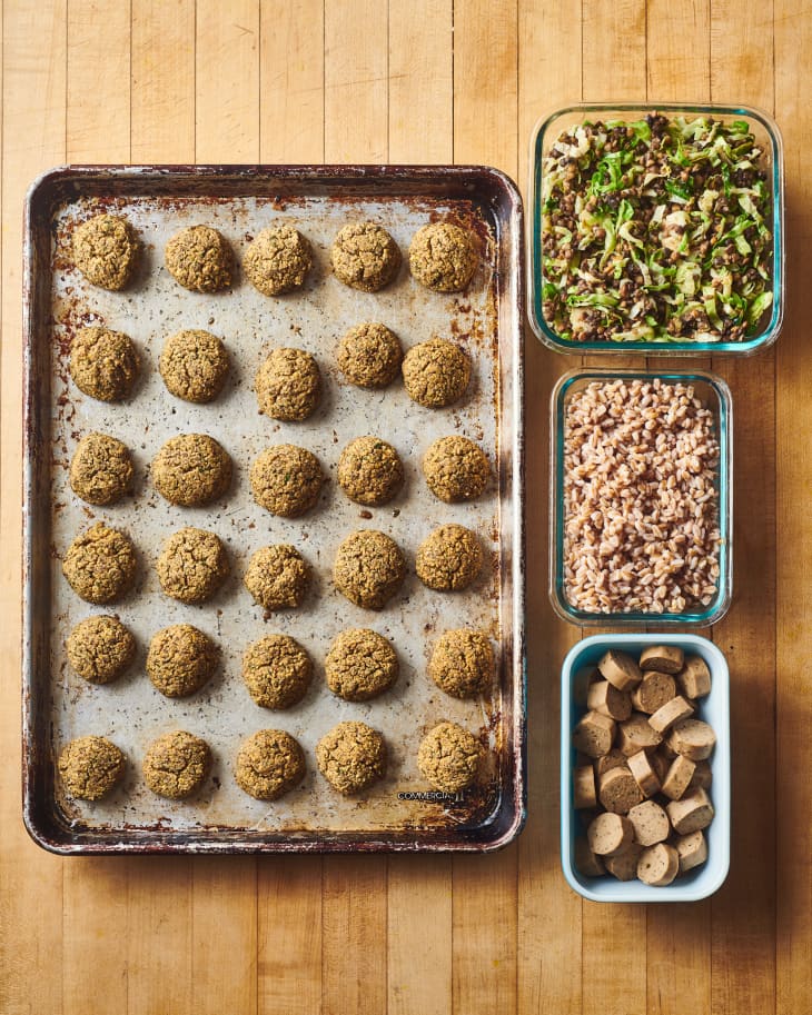 grid of four food items, falafel on a baking sheet, potatoes in a baking dish,  greens in a baking dish, and chickpeas in a baking dish