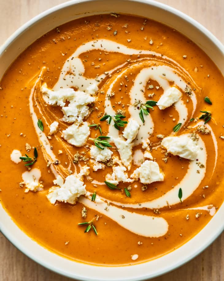 two bowls of Creamy Roasted Red Pepper Soup with Tahini and Feta